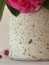 Close-up of a crag and porcelain ceramic vase with pink David Austin roses.