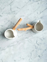 Twig Handled Porcelain Mugs and Jugs with Lichen Orange Glaze
