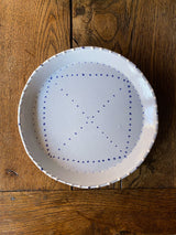 White ceramic plates with painted blue delftware decoration by Emily Mitchell