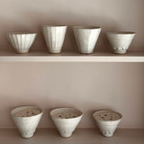 Set of ceramic pots on a neutral background