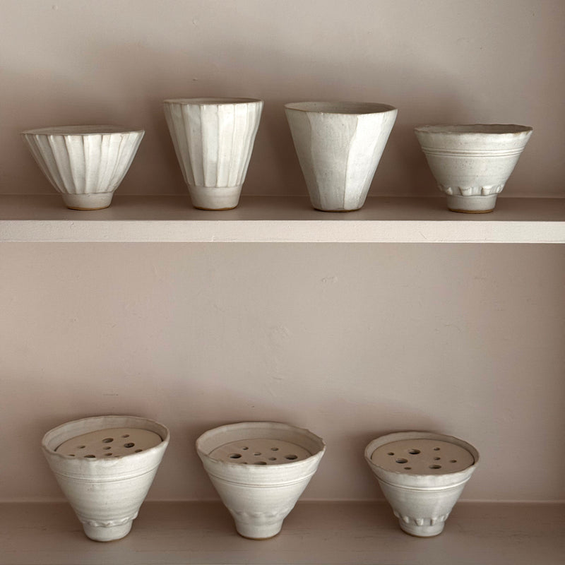 Set of ceramic pots on a neutral background