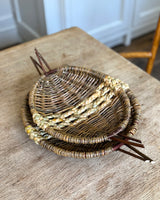 Stack of woven baskets on a wooden table