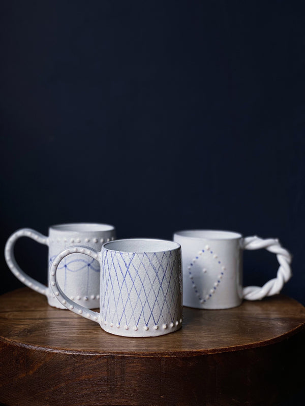 3 ceramic white and blue mugs by Emily MItchell