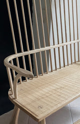 Wooden chair with a slatted backrest in a minimalistic setting